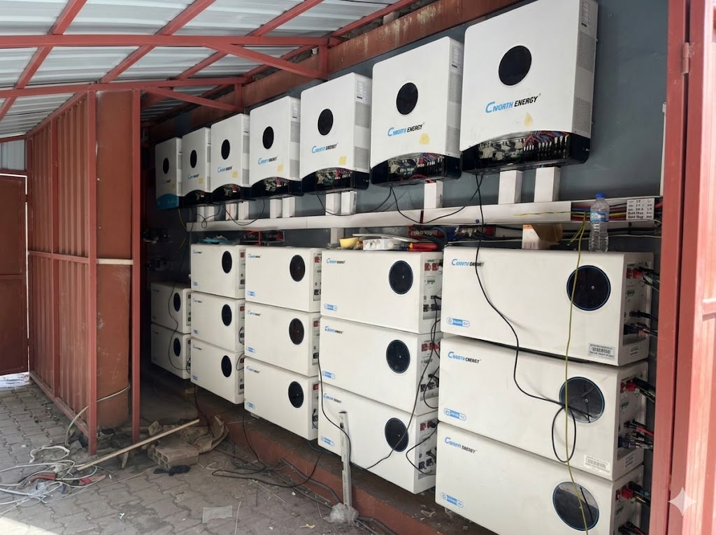 A wall of Cworth hybrid solar inverters and LiFePO4 batteries installed by NilePhase Energy for a commercial site in Uganda