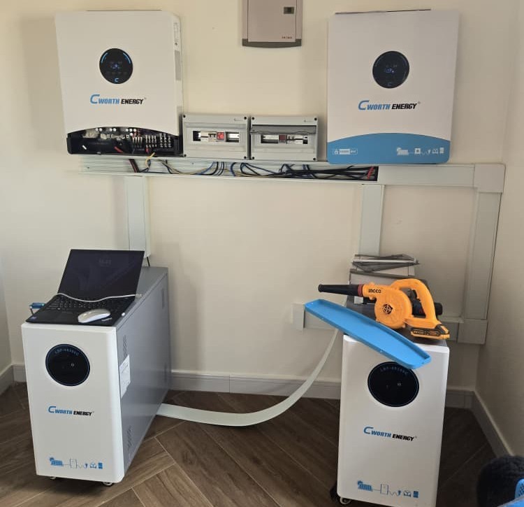 Two wall-mounted hybrid inverters and floor-standing lithium batteries neatly installed and wired by NilePhase Energy in Uganda