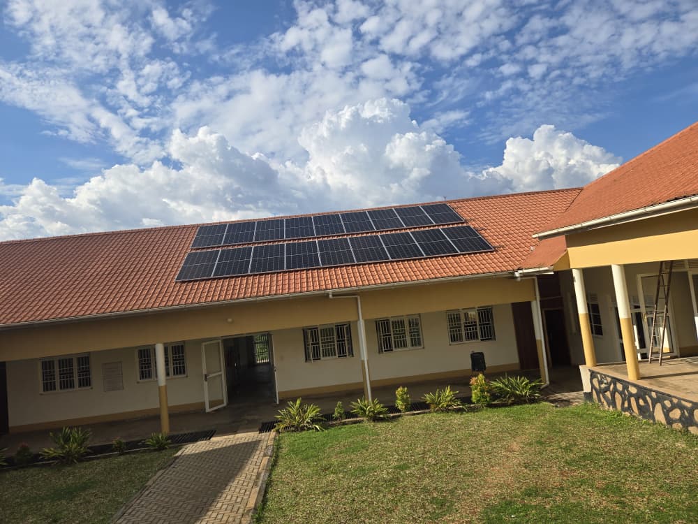 Tier-1 solar panels installed on a tiled roof in Uganda under a blue sky by NilePhase Energy engineers